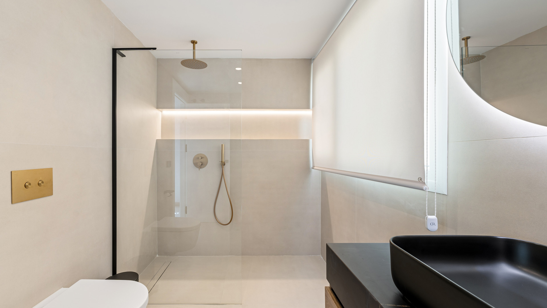 Modern bathroom with a glass shower, stylish fixtures, and ambient lighting. Minimalist design with neutral tones.