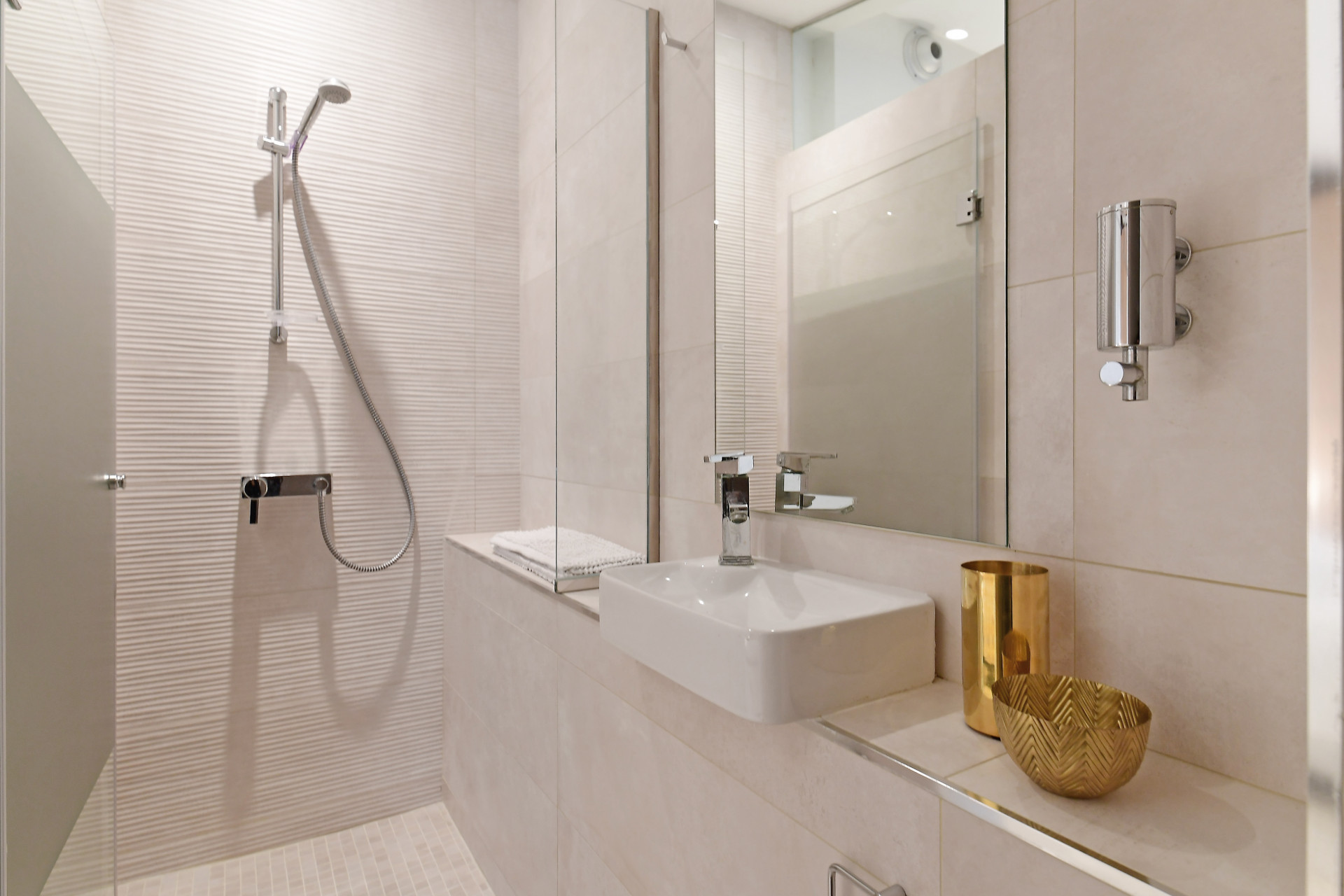 Modern shower room with a glass door, sleek fixtures, and a minimalist design.