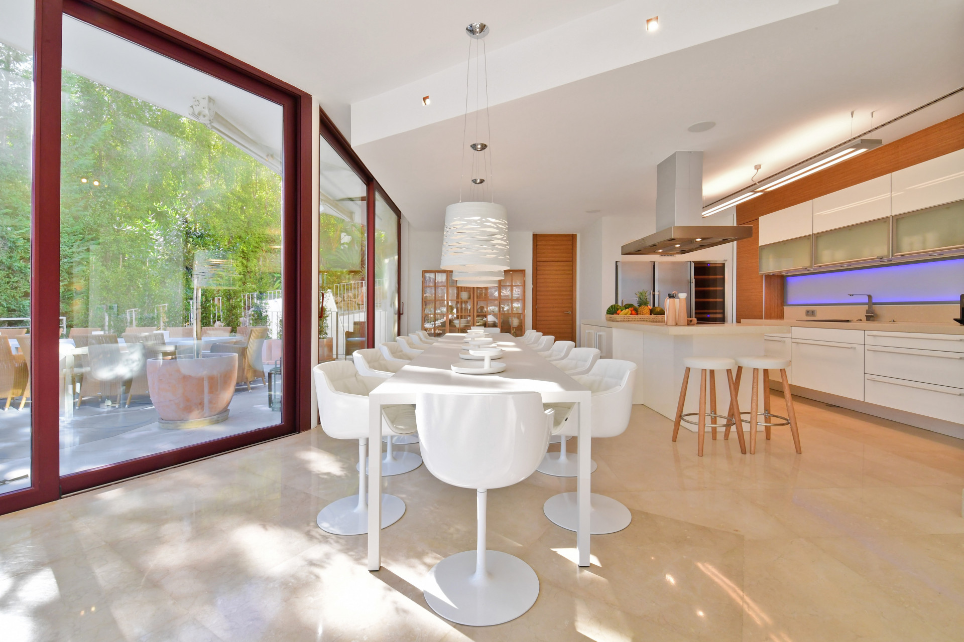 Kitchen view incorporating dining area, modern appliances, and a minimalist aesthetic