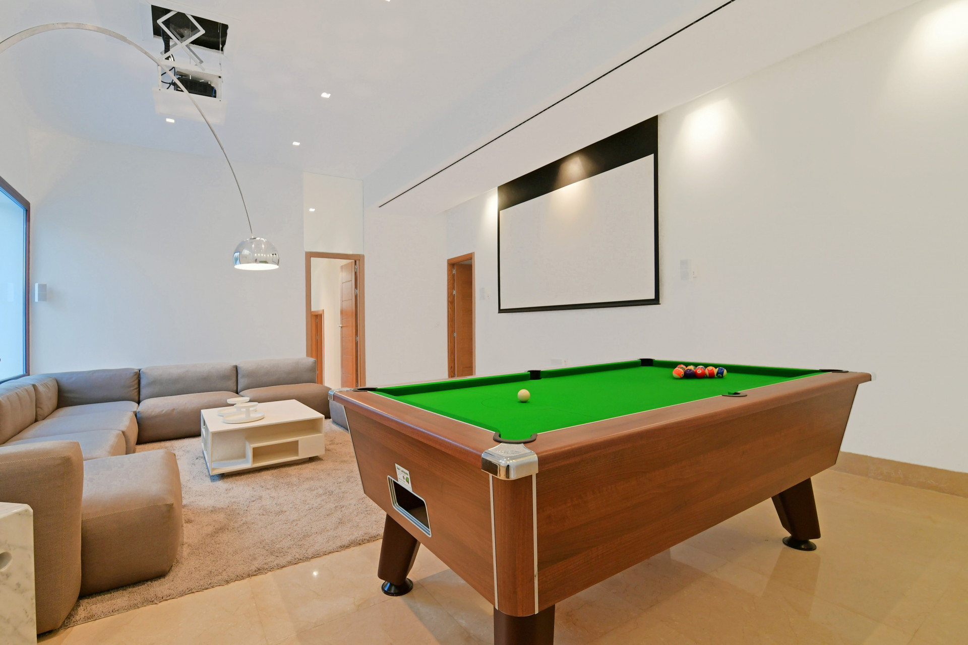 Second view of the game room with a pool table and projector screen