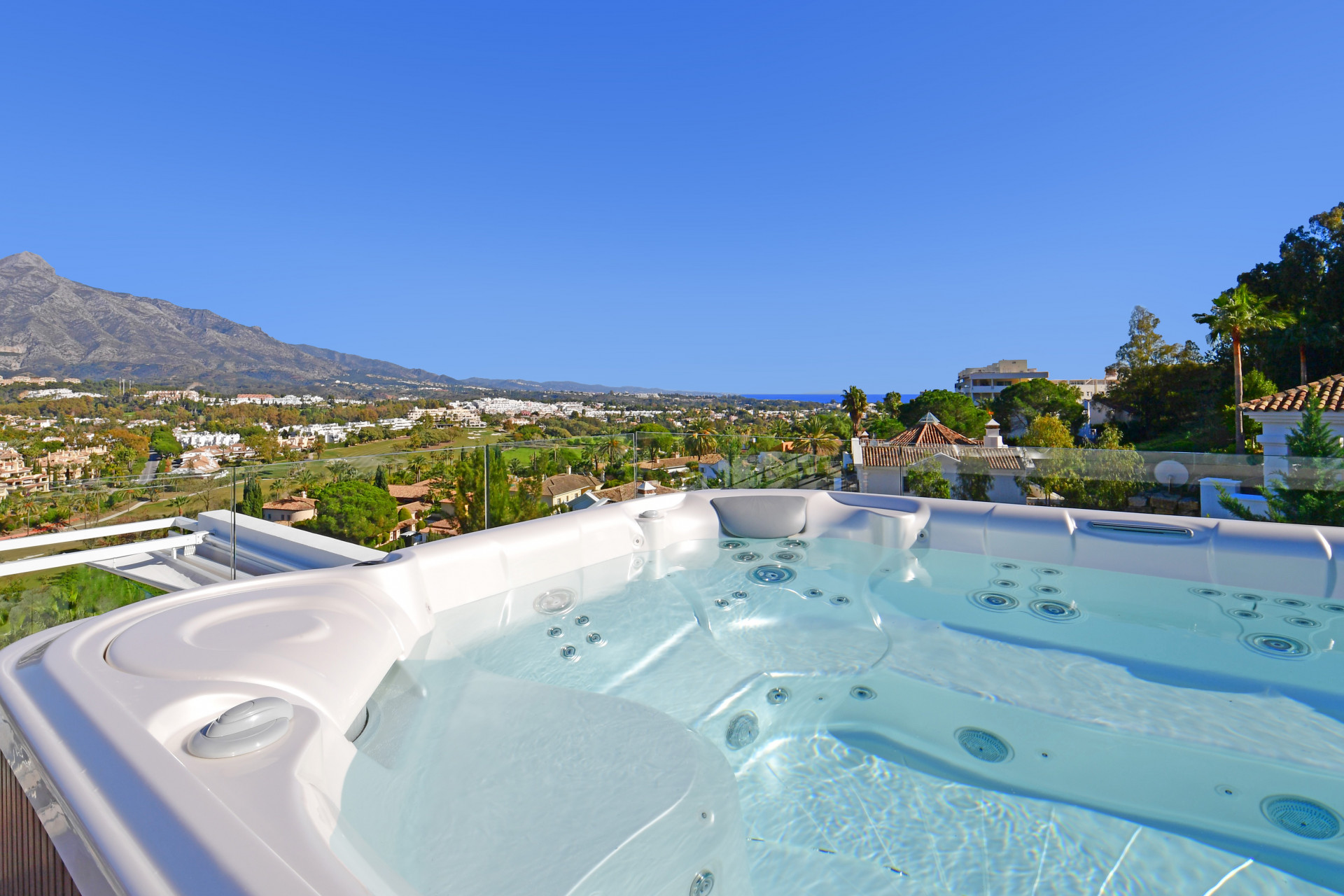 Hot tub with mountain views under a clear blue sky