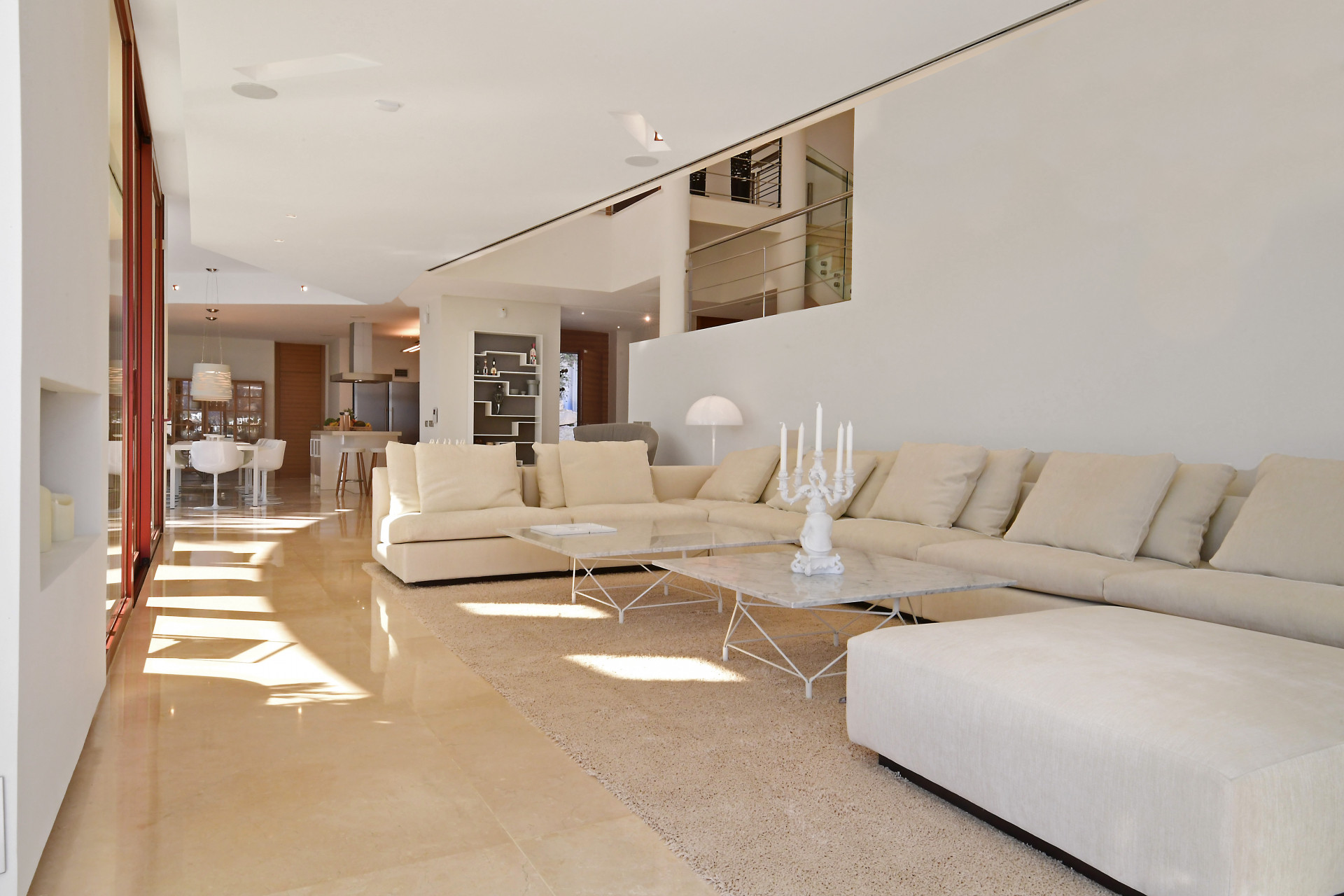 Spacious living area featuring sectional sofa and glass coffee table