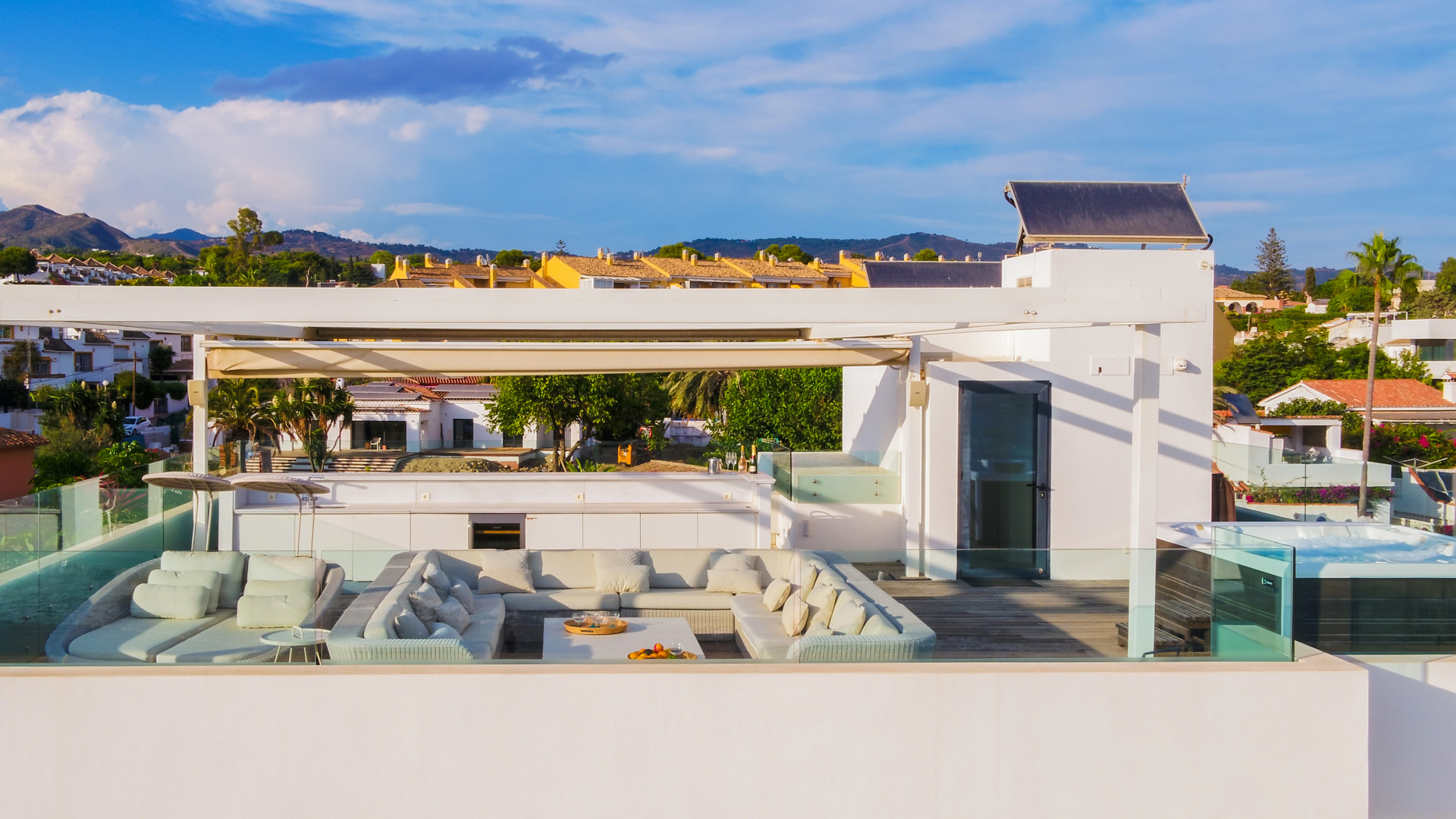 Rooftop terrace with outdoor seating and stunning mountain views.