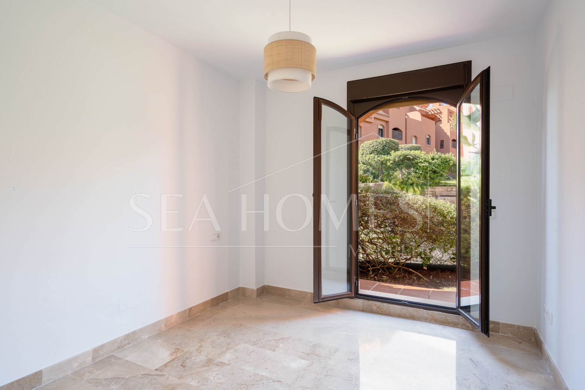 Elegant Coastal Living in Estepona – Corner Garden Apartment with Style & Serenity in Costa Galera