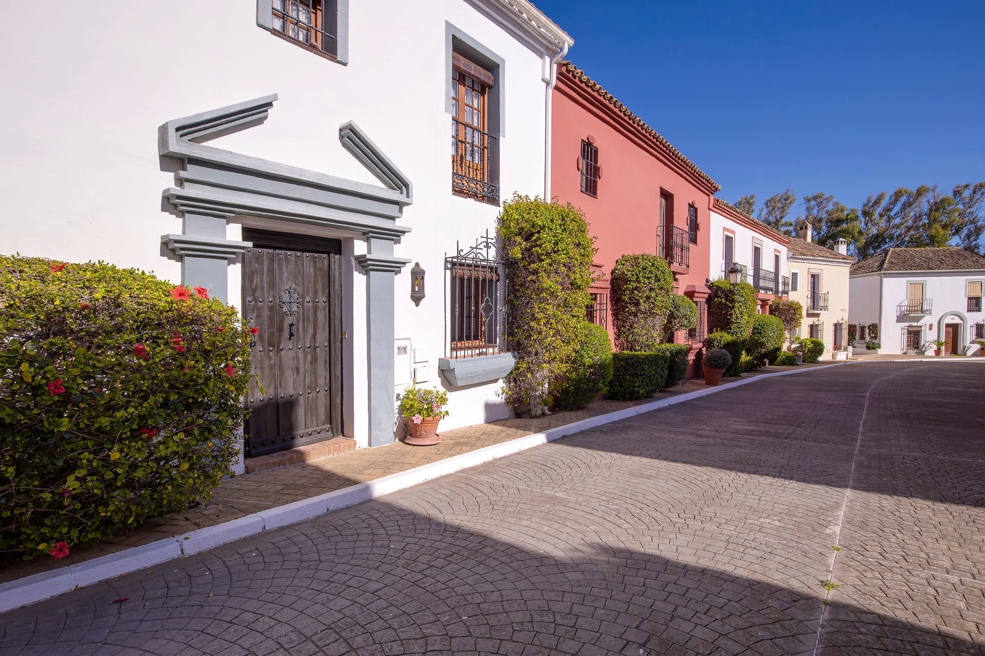 Very spacious corner villa set in a private Andalusian village on the second line of the beach in Guadalmina Baja