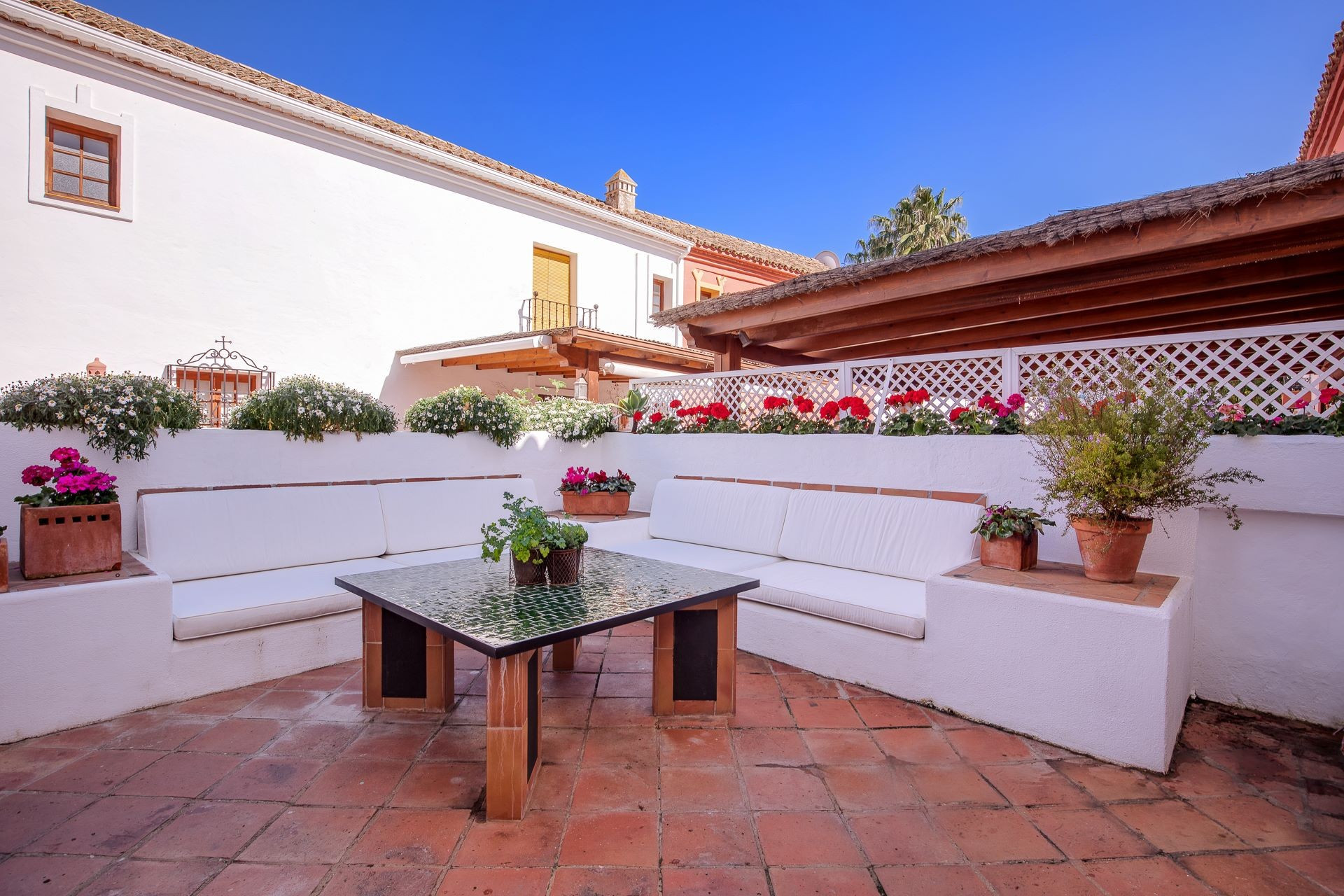Very spacious corner villa set in a private Andalusian village on the second line of the beach in Guadalmina Baja