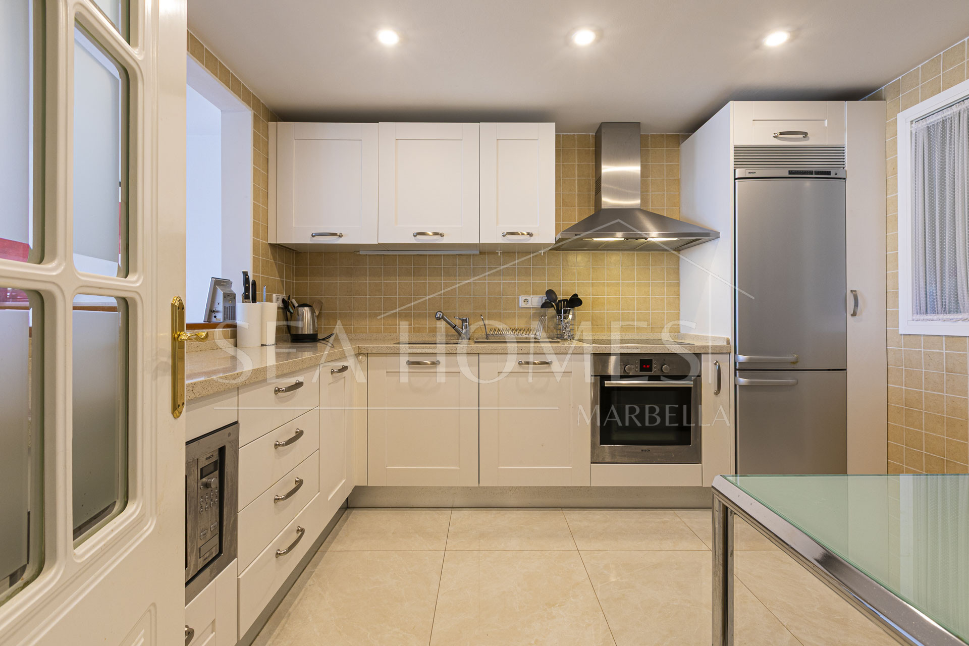 Beautiful south-facing, four bedroom townhouse in Los Almendros, part of the secure Los Arqueros Golf community in Benahavís