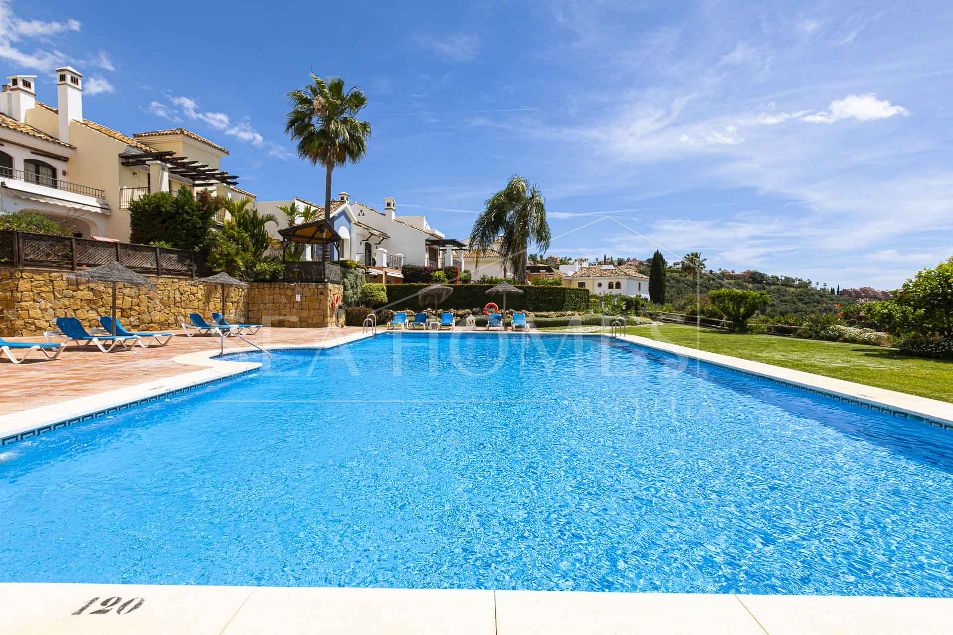 Beautiful south-facing, four bedroom townhouse in Los Almendros, part of the secure Los Arqueros Golf community in Benahavís