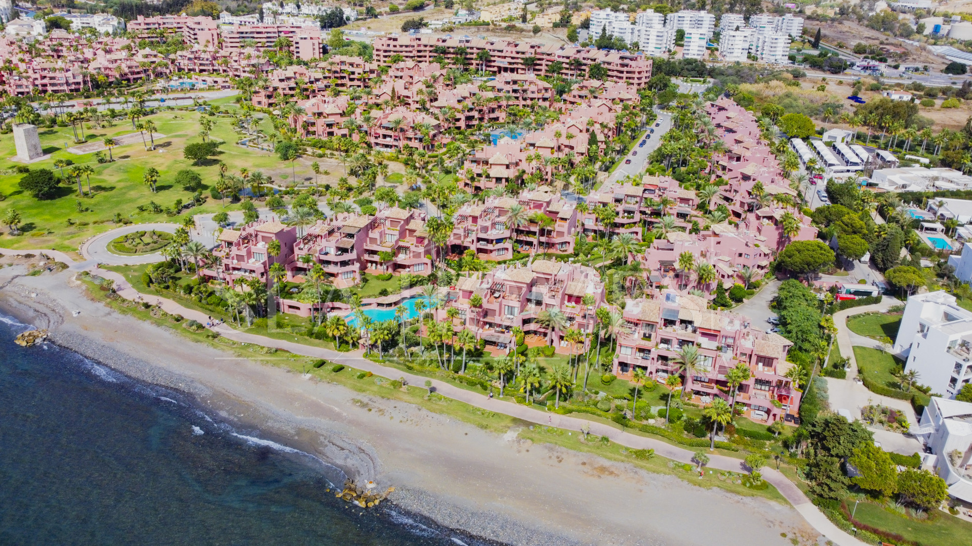 Impeccably renovated, south facing beach front, garden apartment located in the exclusive Menara Beach community on the sought-after New Golden Mile