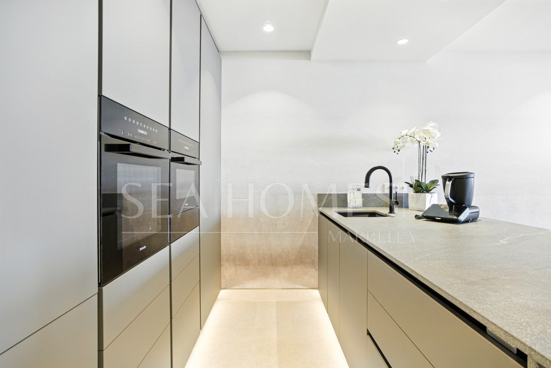 Impeccably renovated, south facing beach front, garden apartment located in the exclusive Menara Beach community on the sought-after New Golden Mile