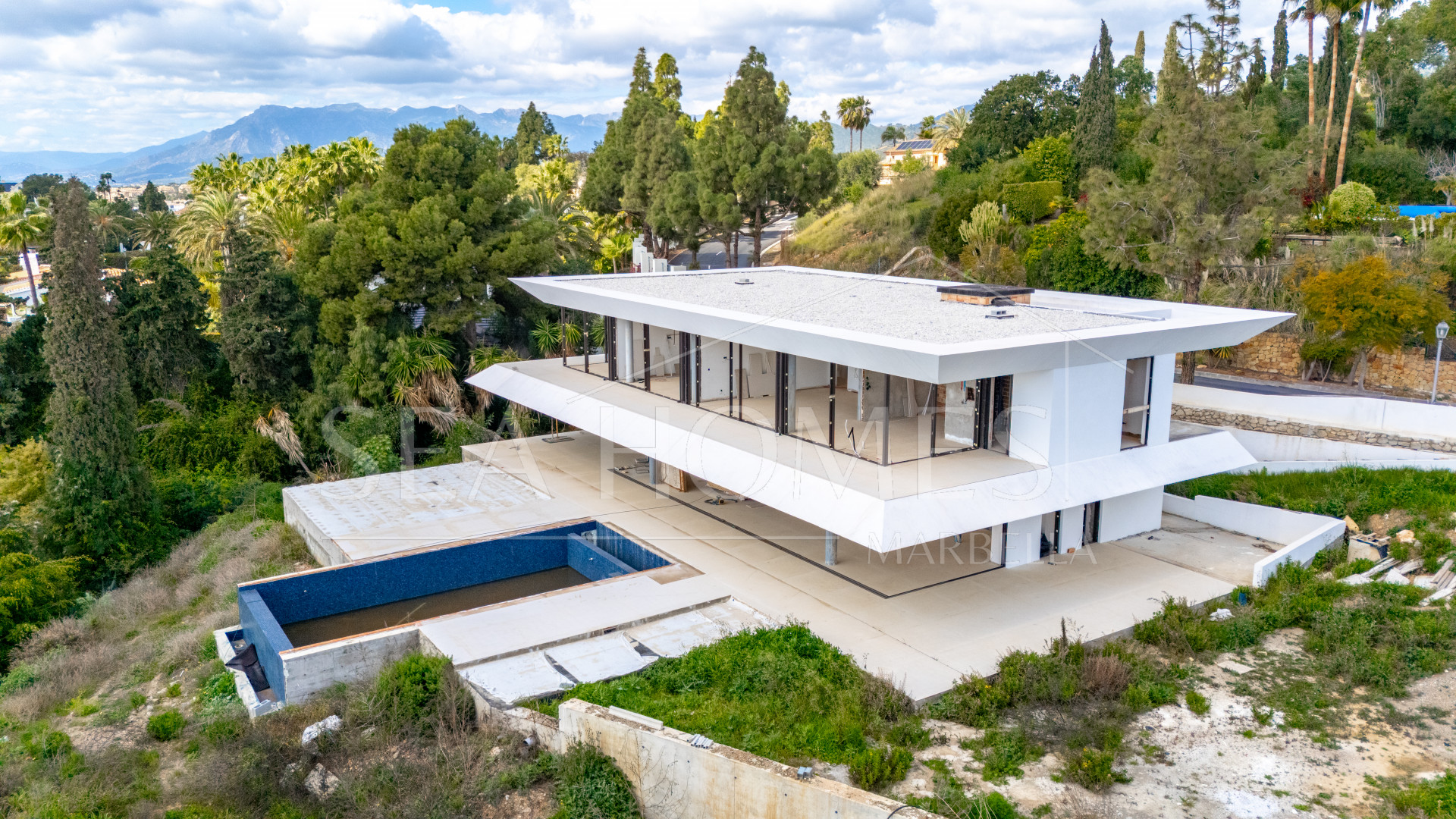 Experience unparalleled luxury with this soon-to-be-completed turnkey villa in the prestigious Hacienda Las Chapas