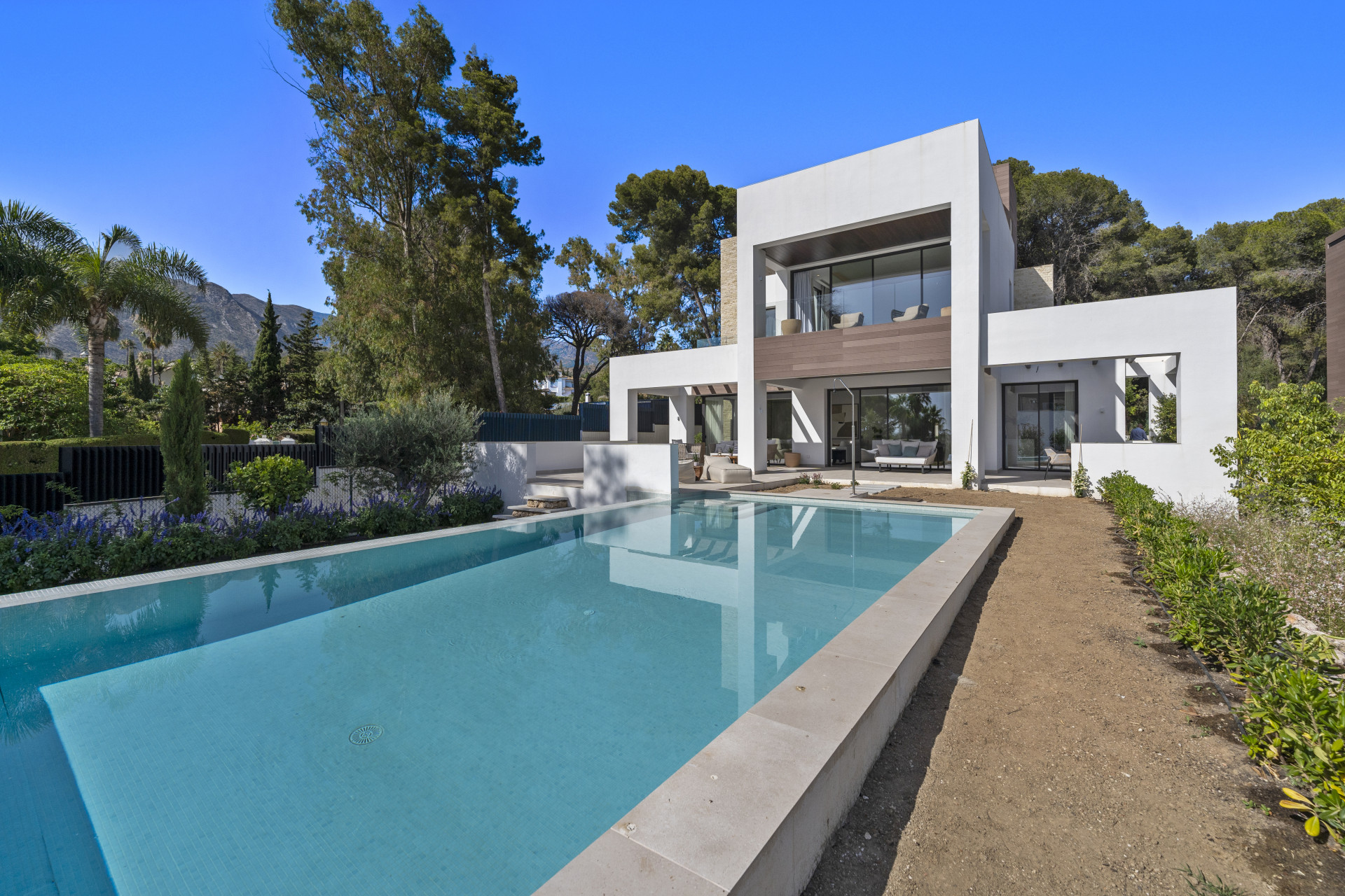 Deluxe modern four bedroom, south facing villa nestled within a luxury gated community on Marbella's Golden Mile.
