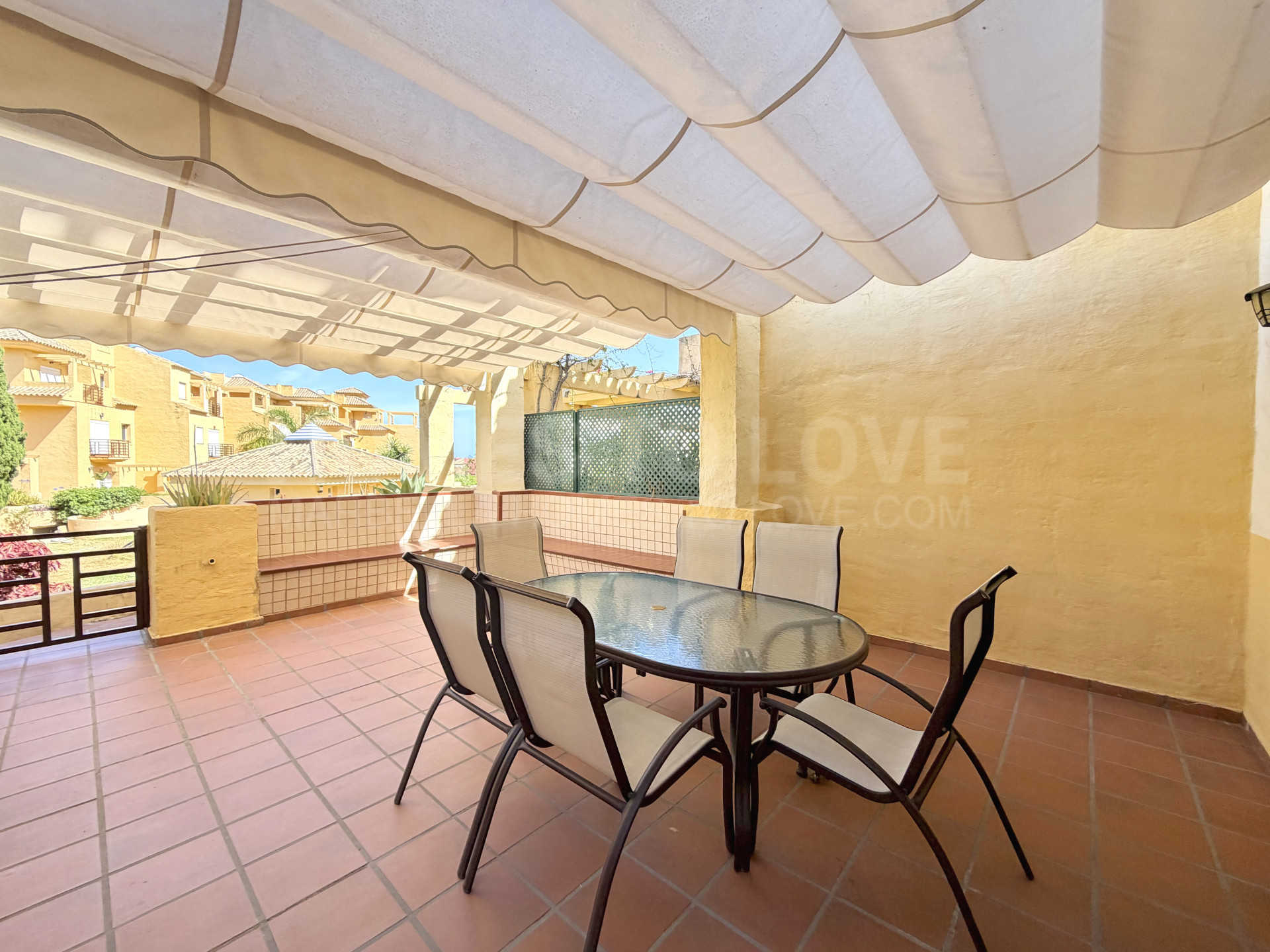 Town house in Cancelada, Estepona East with sea and mountain views, private garden, roof terrace, communal pool and garage for two cars.
