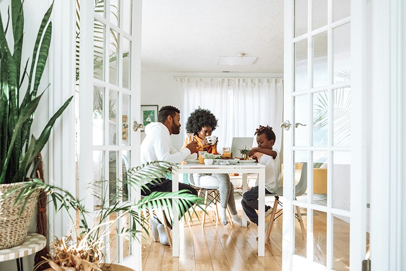 a family dining in their new house, tips after buying a house