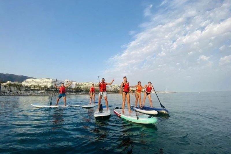 a group of paddle surfers, paddle surfing is one of the water sports and activities in Marbella