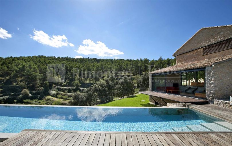 Exclusive designer villa of stone and steel at the top of a mountain in Bocairent, Valencia.
