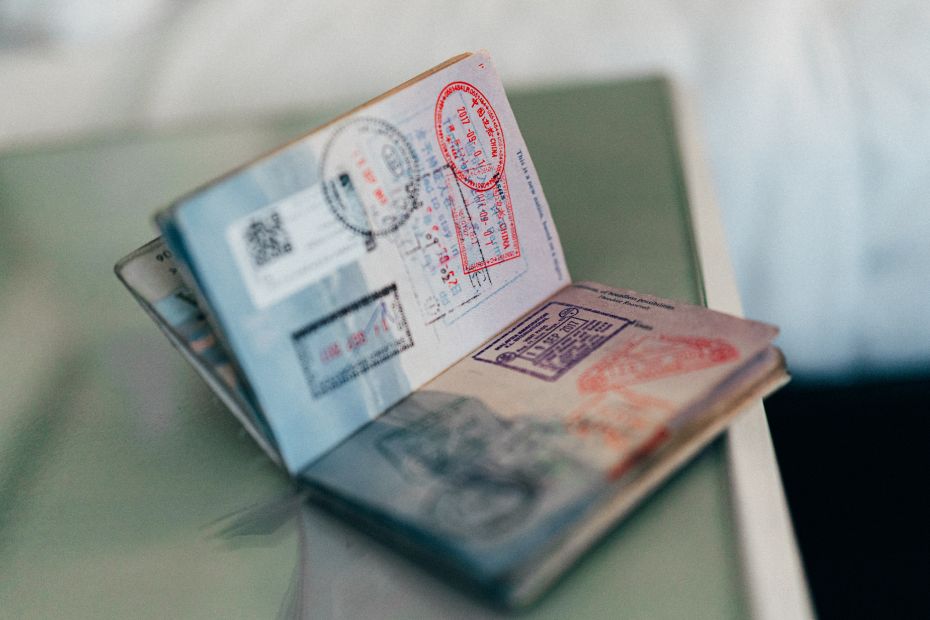 Photograph of a passport open on the visa page with various stamps