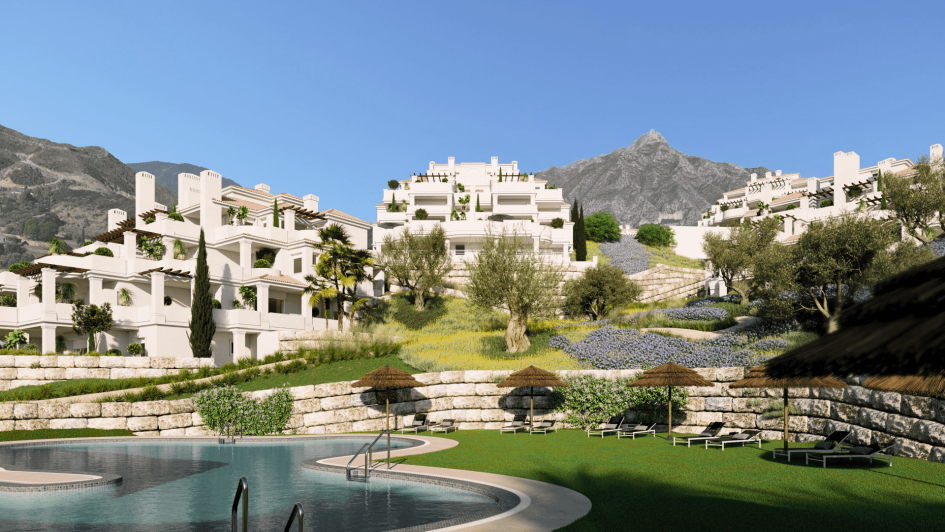 The image shows a pool in front of a large white building with a mountain in the background. It is a luxurious real estate property with outdoor landscaping. The setting includes trees, grass, and a clear blue sky. 