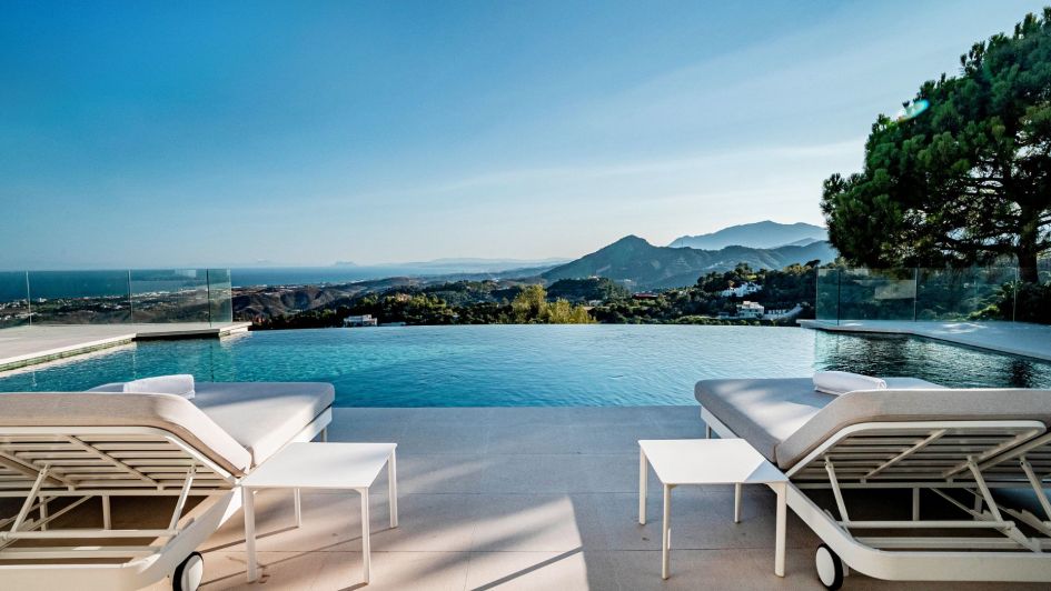 Pool and sun loungers overlooking the Mediteranean sea in a luxury property for sale in Marbella