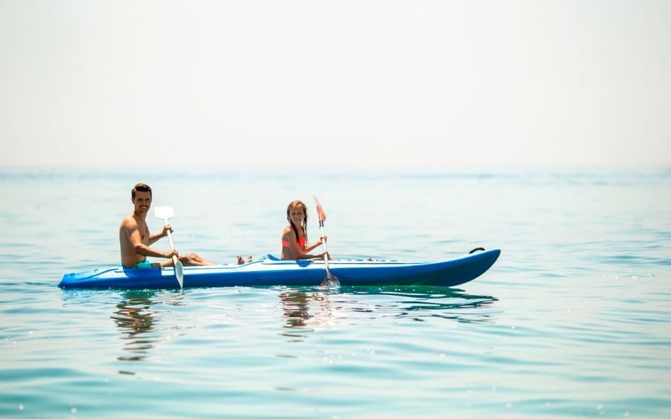 Family kayaking in the sea