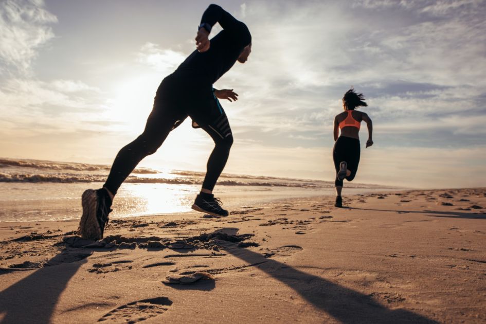 Photo of people running at the beach