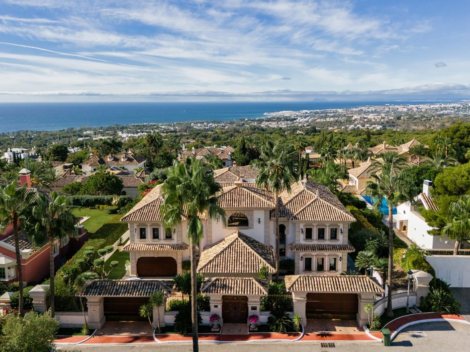 Luxury Mediterranean villa with panoramic sea views, elegant architecture, and exclusive gated entrance in a prestigious hillside community located in Sierra Blanca