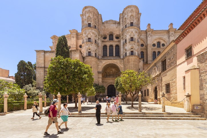 Málaga Tourists walk past the beautiful historic cathedral