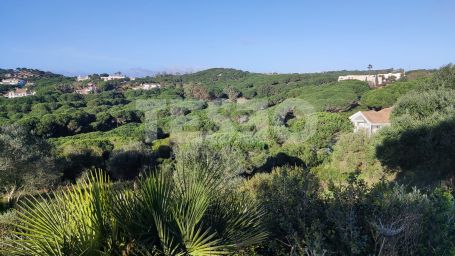 Elevated plot in Sotogrande Alto with panoramic views of the golf course and lake, featuring an approved contemporary project and ready to build.